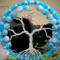 tree of life accents against a black background bringing out the beautiful sky blue colors